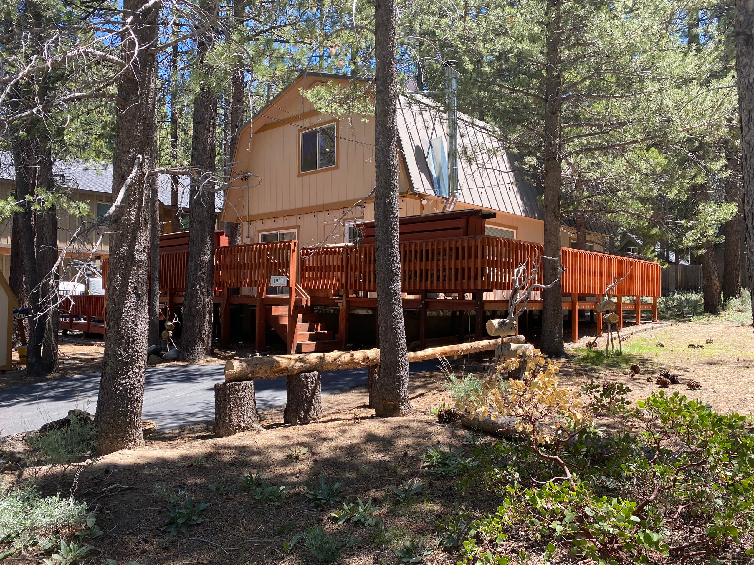 CoatneyCabin, a two-story house with a wraparound deck among the pines at 1901 Susquehana Drive, South Lake Tahoe